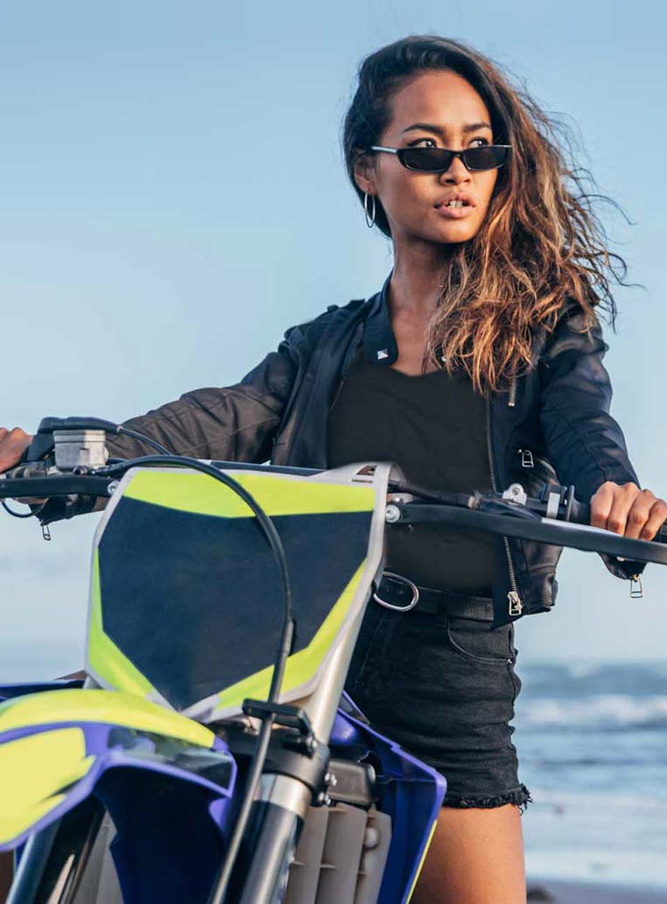 woman on a motorbike at the beach